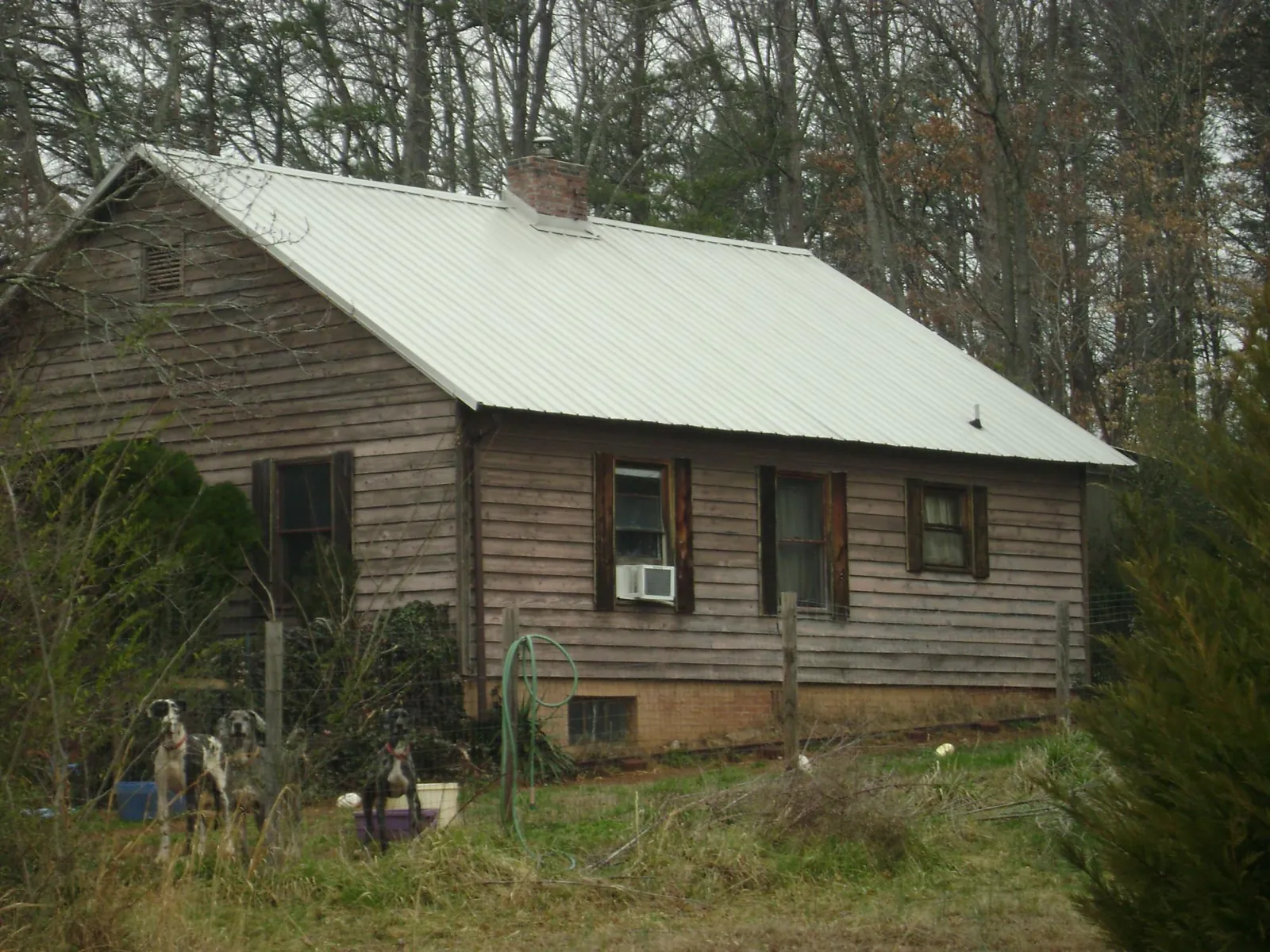 White metal roof on an old wood sided farmhouse, from a Metal Roof Installation job in West River